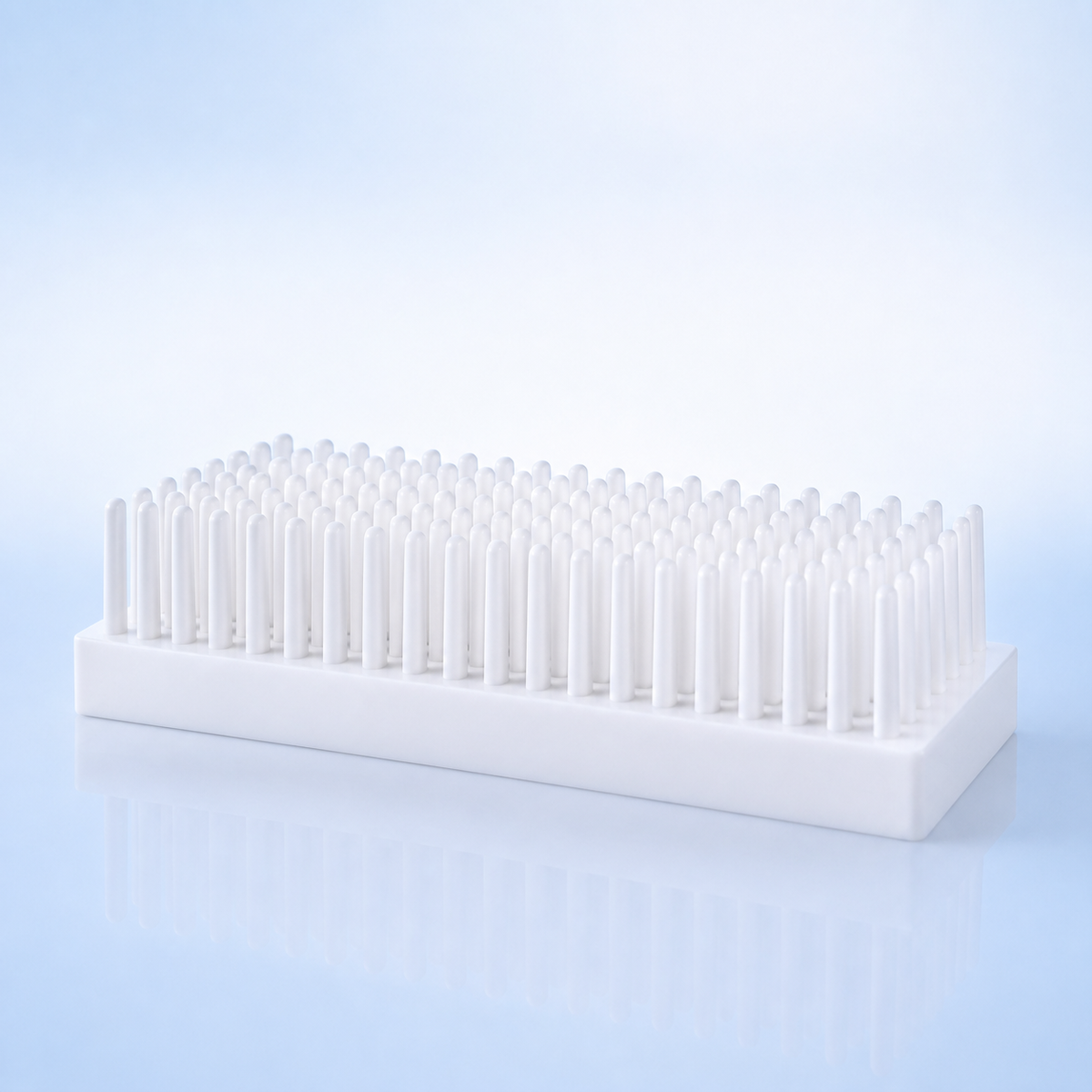 White 102-post laboratory tube drying rack air-drying washed tubes on a blue-lit lab bench