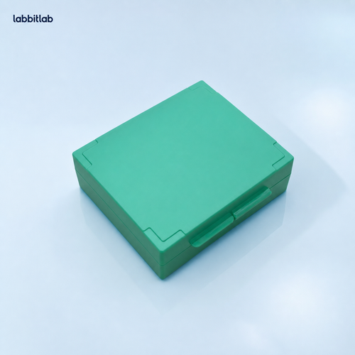 Green standard 25-slide microscope slide storage box on a pale blue laboratory background