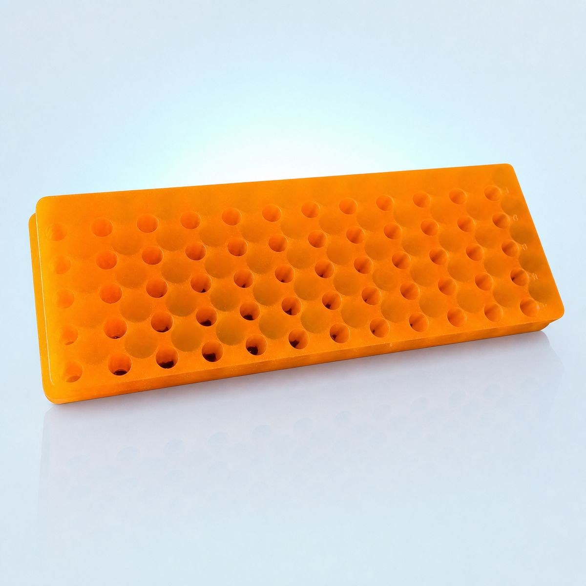 60-well orange double-sided microcentrifuge tube rack on an icy blue lab background