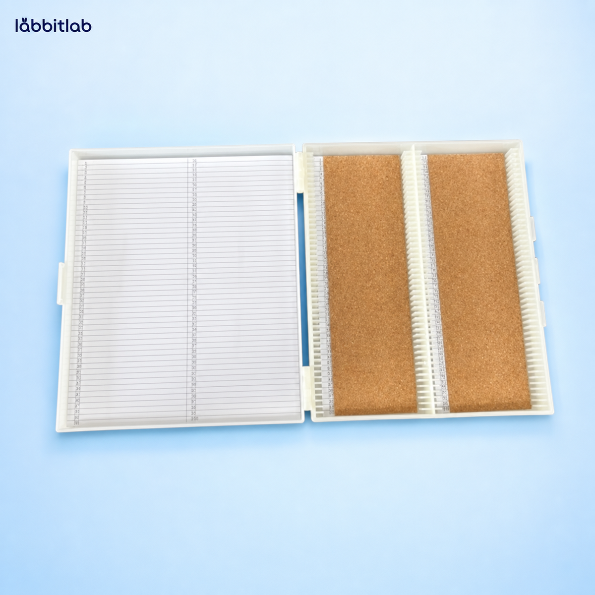 Open cork-lined microscope slide storage box with numbered inventory index